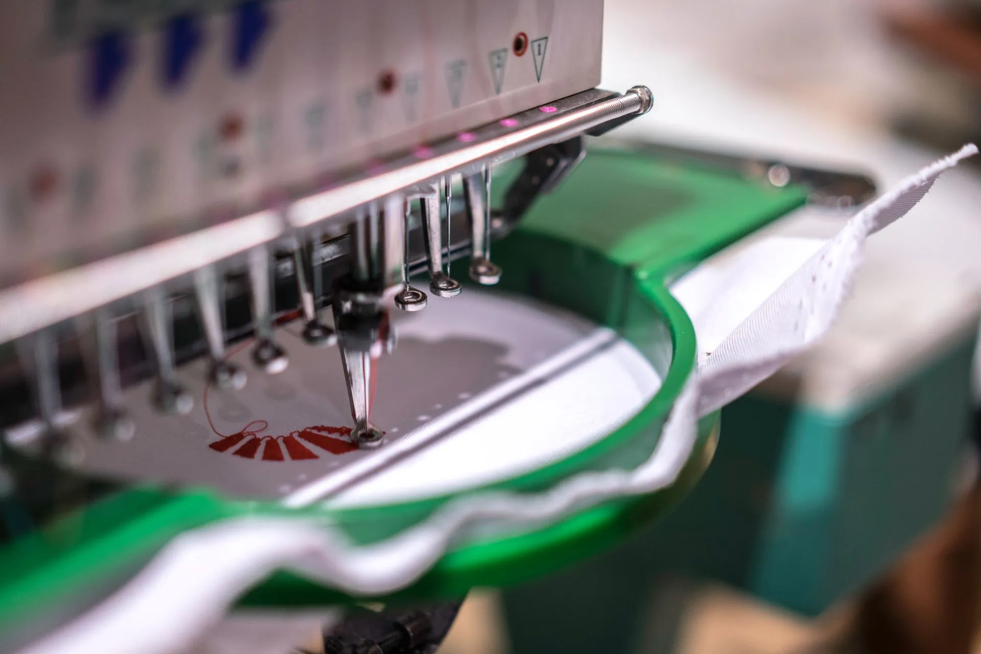 Industrial embroidery machine stitching a design