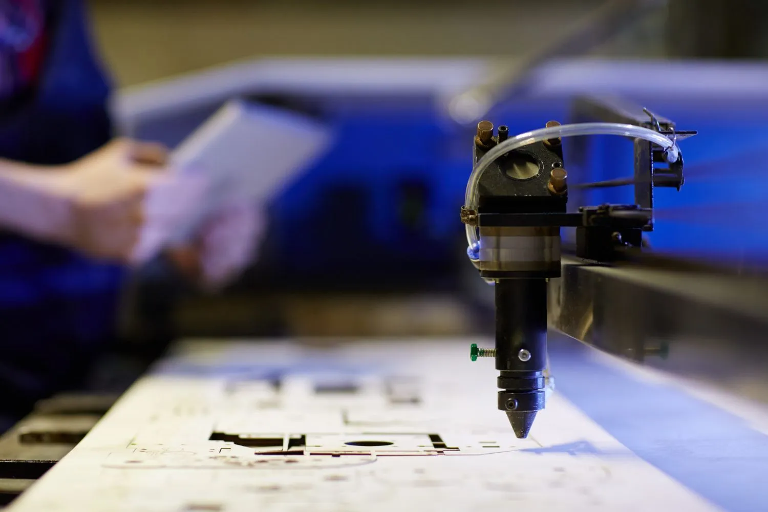 Laser engraving machine cutting a flat panel